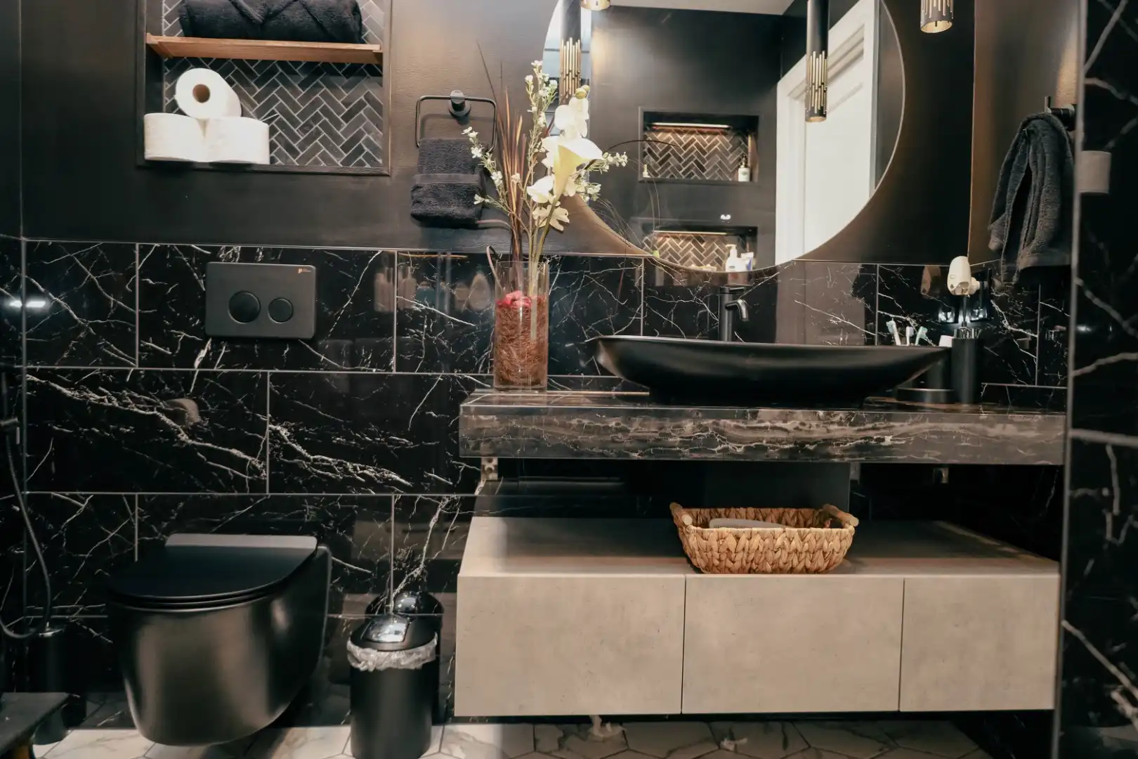 Complete black bathroom remodel with a floating vanity and round mirror in Ellicott City MD.