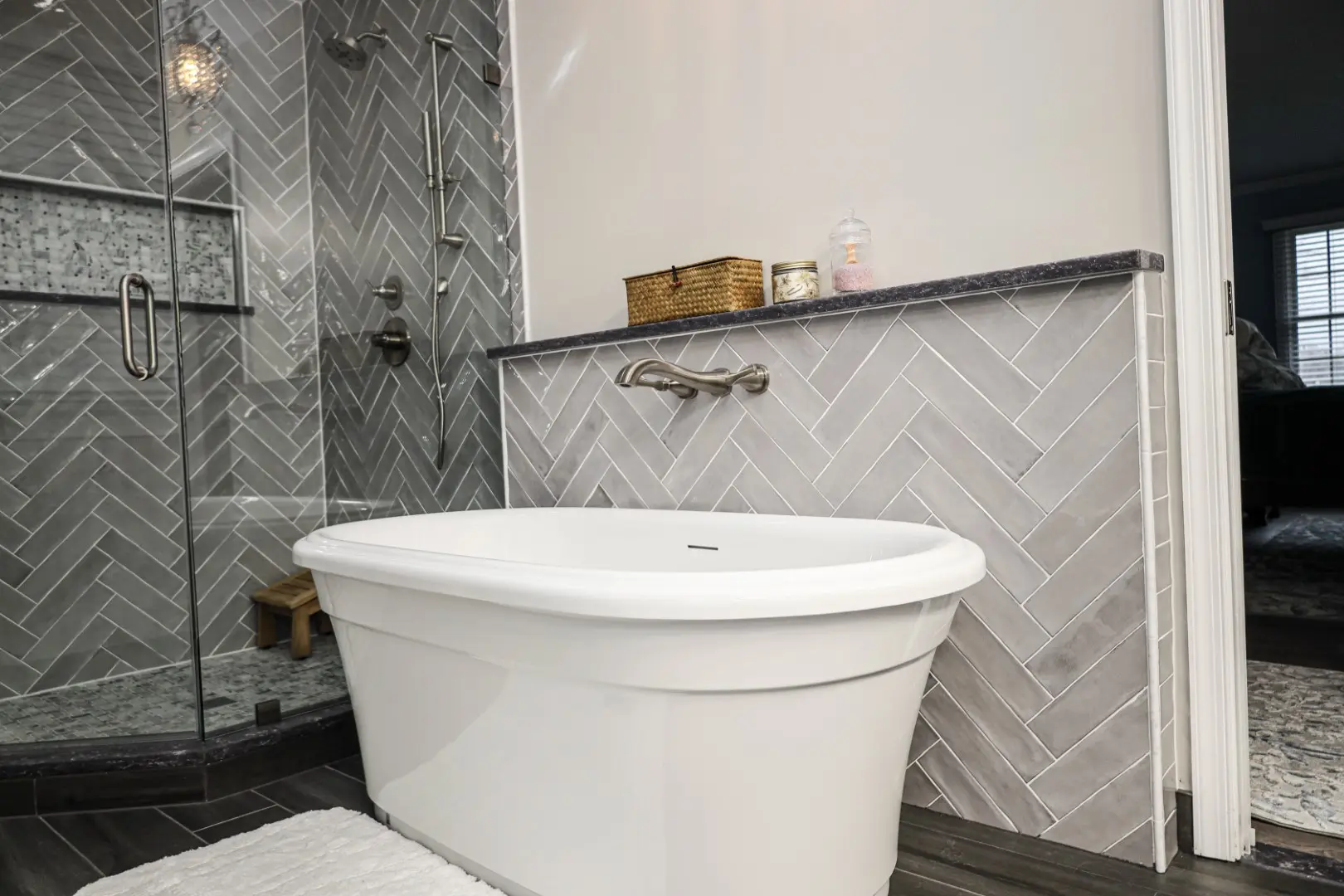 Panoramic view of a beautifully renovated master bathroom from the entrance, showing the double vanity, walk-in shower, and freestanding tub in Columbia, MD.