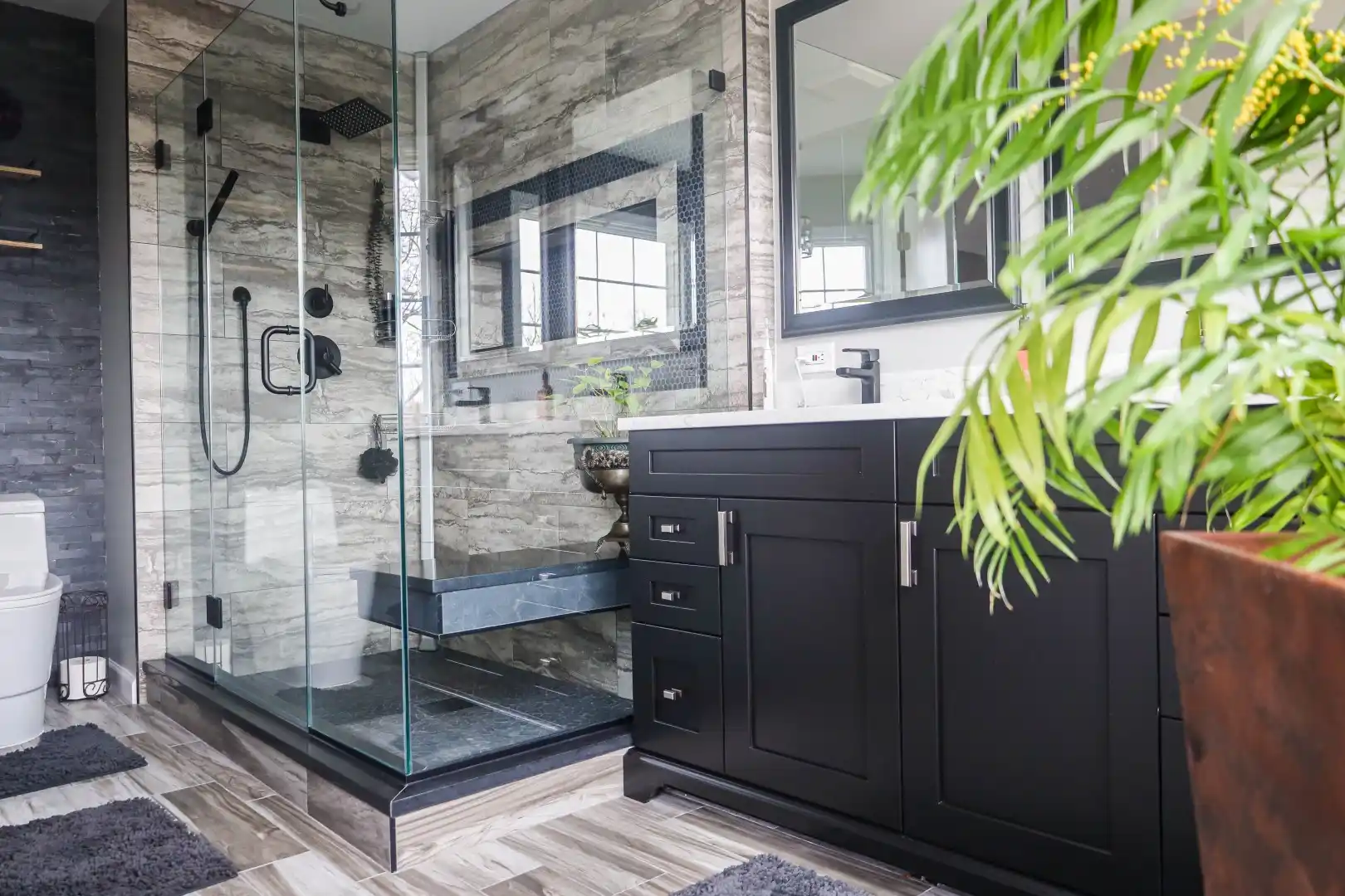 Complete master bathroom remodeling in Westminster City MD featuring custom dark wood cabinets and a walk-in shower by Anka Design Studio.