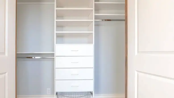 Custom closets maximizing a small reach-in closet space by Anka Design Studio
