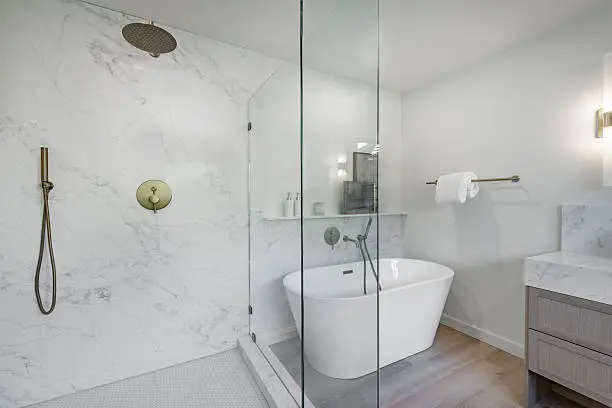 Luxury bathroom remodeling with freestanding tub and walk-in shower by Anka Design Studio