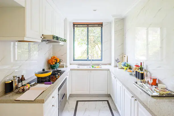 Modern kitchen with white shaker cabinets and marble countertops